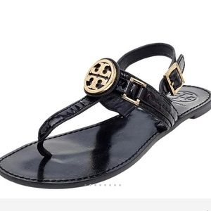 Tory Burch Cassia Patent leather T-strap sandals with gold metal accents